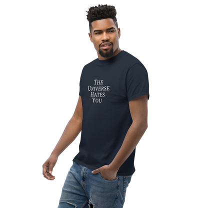 "The Universe Hates You" printed on a navy unisex classic tee worn by a male