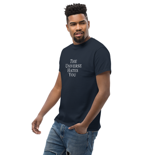 "The Universe Hates You" printed on a navy unisex classic tee worn by a male