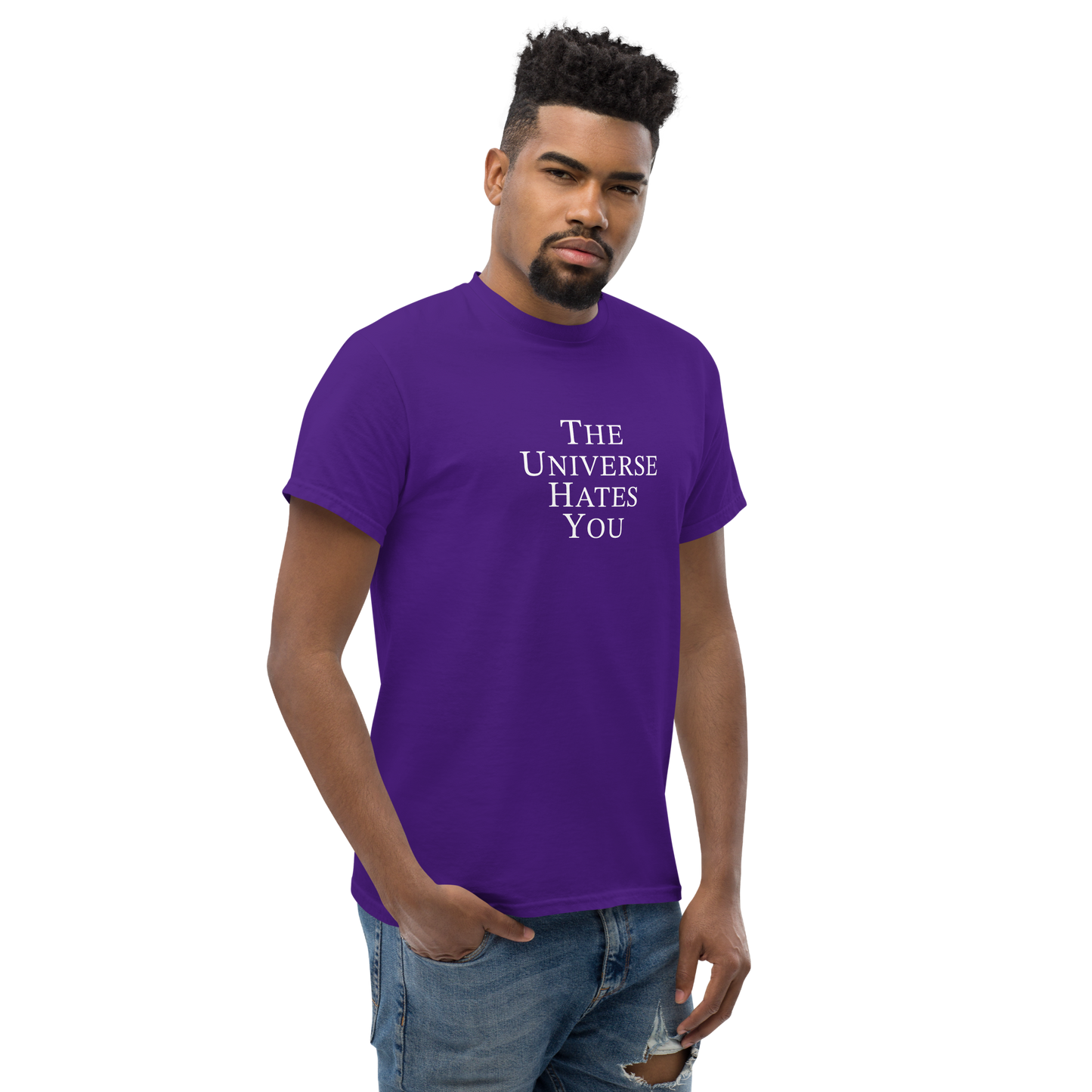 "The Universe Hates You" printed on a purple unisex classic tee worn by a male