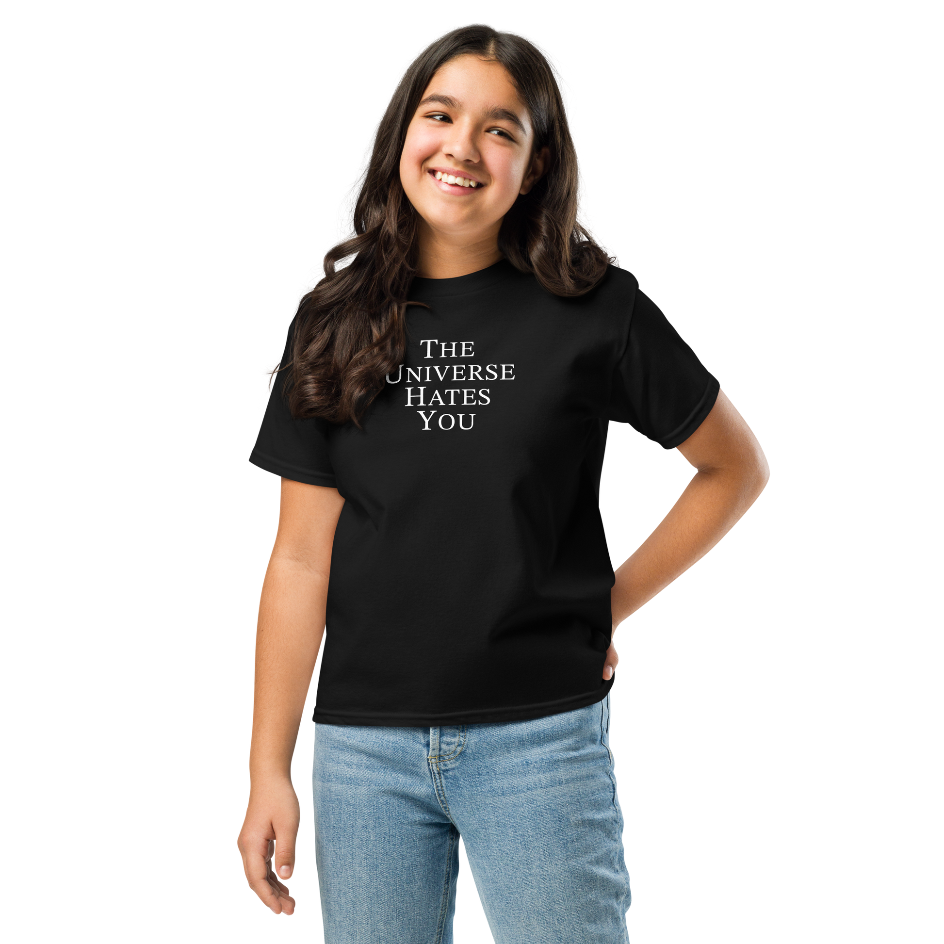"The Universe Hates You" printed on a black youth classic tee worn by a female