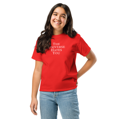 "The Universe Hates You" printed on a red youth classic tee worn by a female