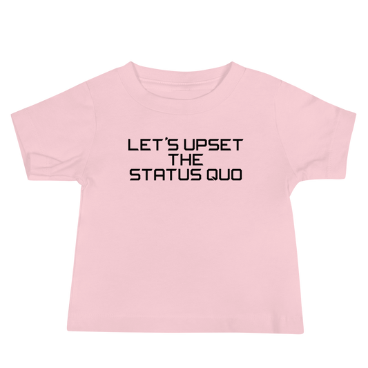 "Let's upset the status quo!" printed on a pink baby jersey short sleeve tee laying on a flat surface