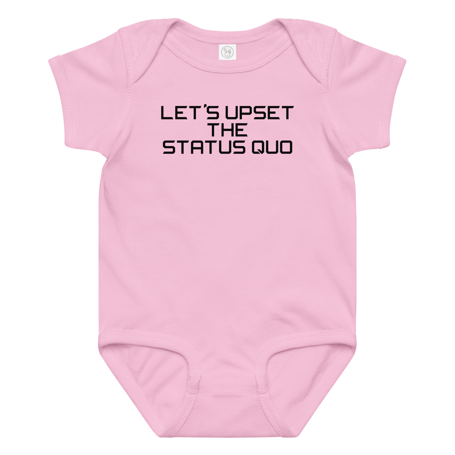 "Let's upset the status quo!" printed on a pink baby jersey bodysuit laying on a flat surface amongst other clothes