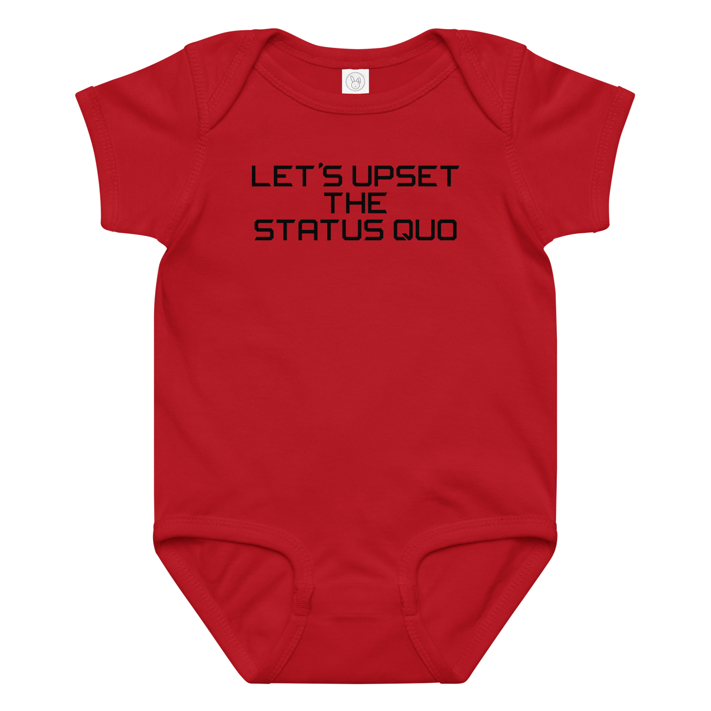 "Let's upset the status quo!" printed on a red baby jersey bodysuit laying on a flat surface amongst other clothes