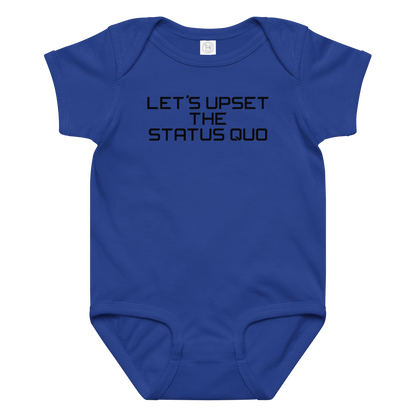 "Let's upset the status quo!" printed on a royal baby jersey bodysuit laying on a flat surface amongst other clothes