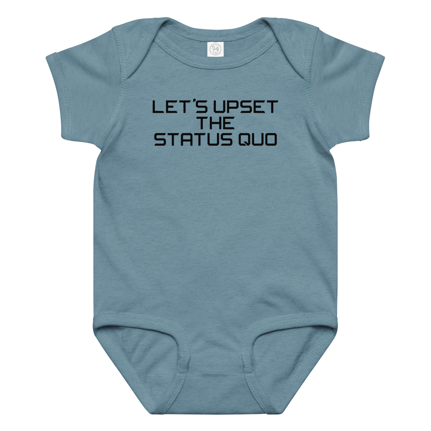 "Let's upset the status quo!" printed on a vintage indigo baby jersey bodysuit laying on a flat surface amongst other clothes