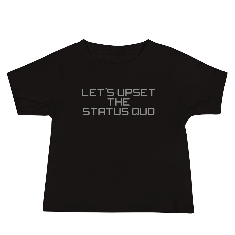 "Let's upset the status quo!" printed on a black baby jersey short sleeve tee laying on a flat surface
