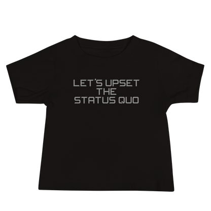 "Let's upset the status quo!" printed on a black baby jersey short sleeve tee laying on a flat surface