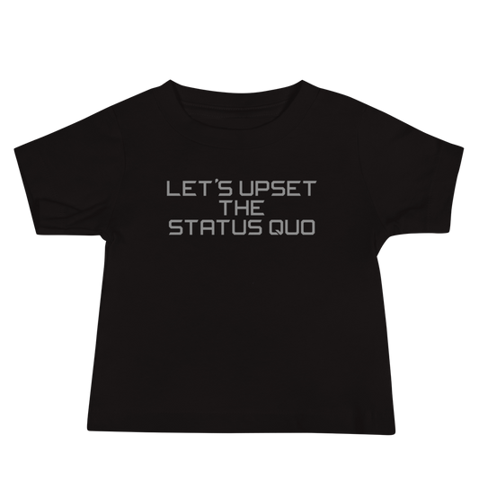 "Let's upset the status quo!" printed on a black baby jersey short sleeve tee laying on a flat surface