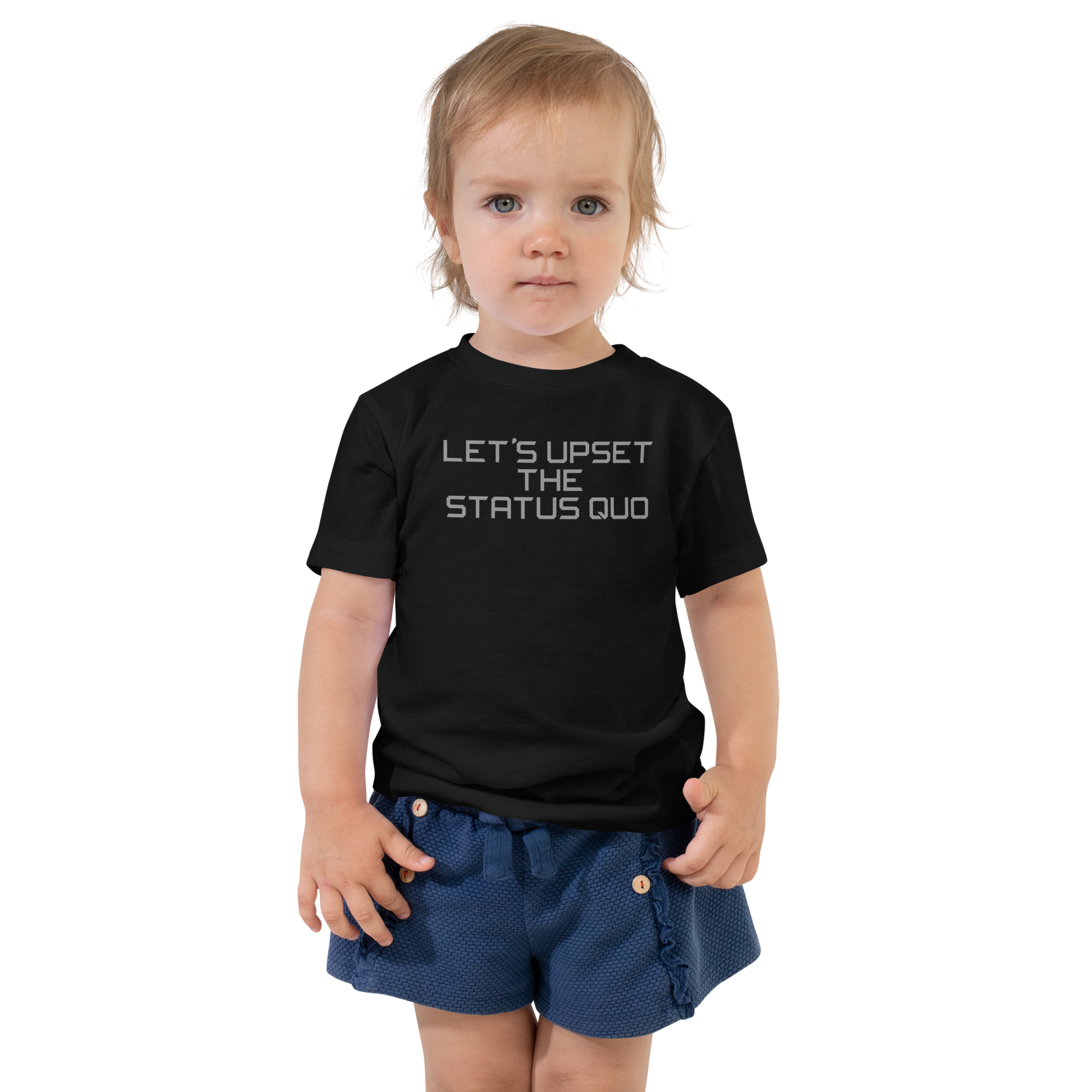 "Let's upset the status quo!" printed on a black toddler short sleeve tee worn by a female