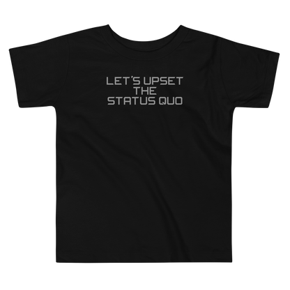 "Let's upset the status quo!" printed on a black toddler short sleeve tee laying on a flat surface