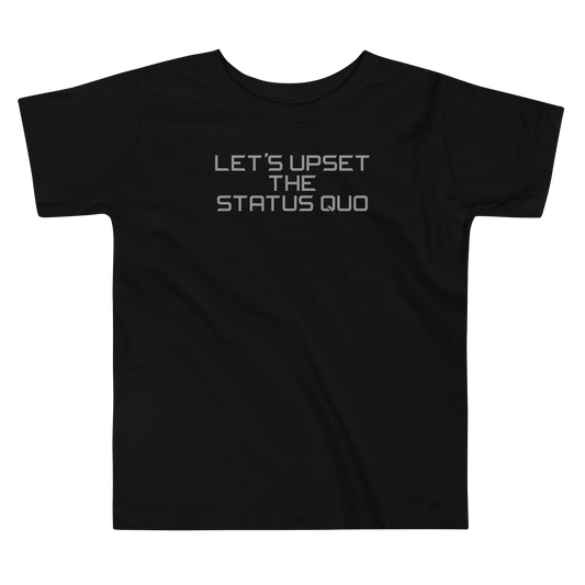 "Let's upset the status quo!" printed on a black toddler short sleeve tee laying on a flat surface
