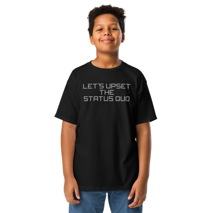 "Let's upset the status quo!" printed on a black youth classic tee worn by a male