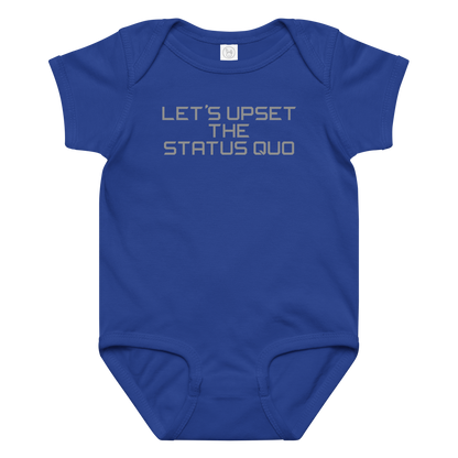 "Let's upset the status quo!" printed on a royal baby jersey bodysuit laying on a flat surface amongst other clothes