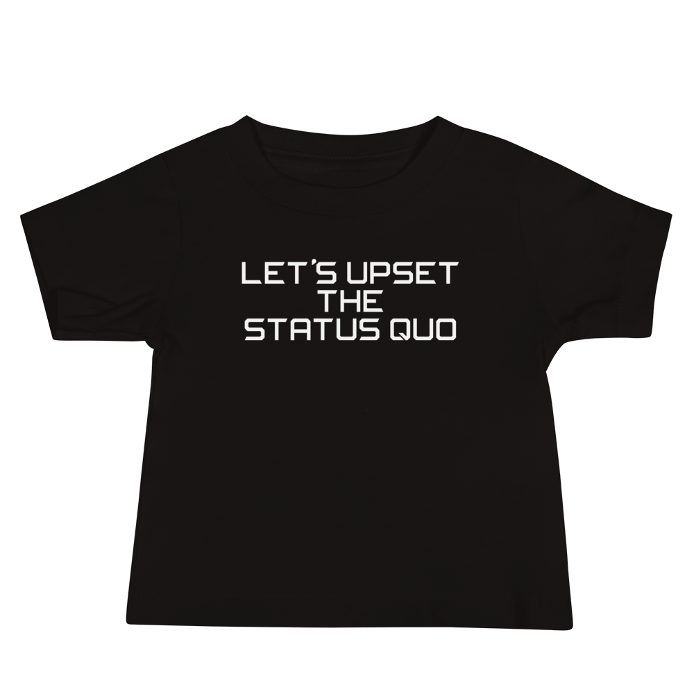"Let's upset the status quo!" printed on a black baby jersey short sleeve tee laying on a flat surface