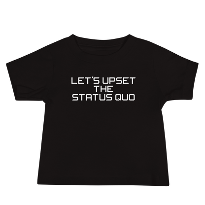 "Let's upset the status quo!" printed on a black baby jersey short sleeve tee laying on a flat surface