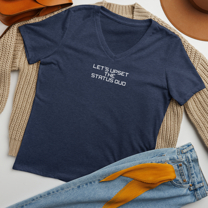 "Let's upset the status quo!" printed on a heather navy women's relaxed v-neck t-shirt laying on a flat surface amongst other clothes