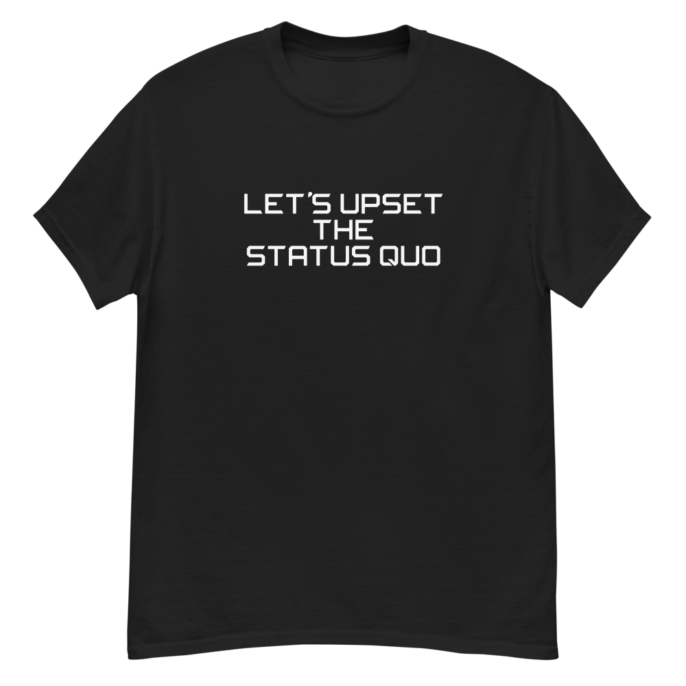 "Let's upset the status quo!" printed on a black unisex classic tee laying on a flat surface