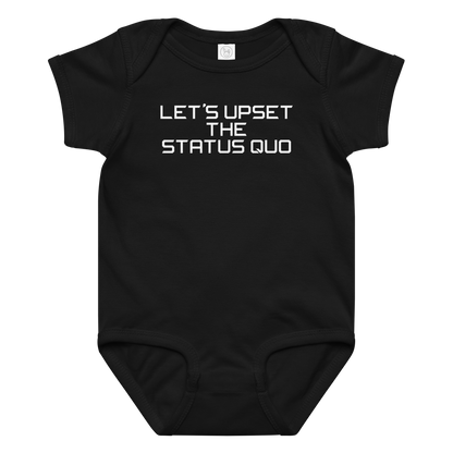 "Let's upset the status quo!" printed on a black baby jersey bodysuit laying on a flat surface amongst other clothes