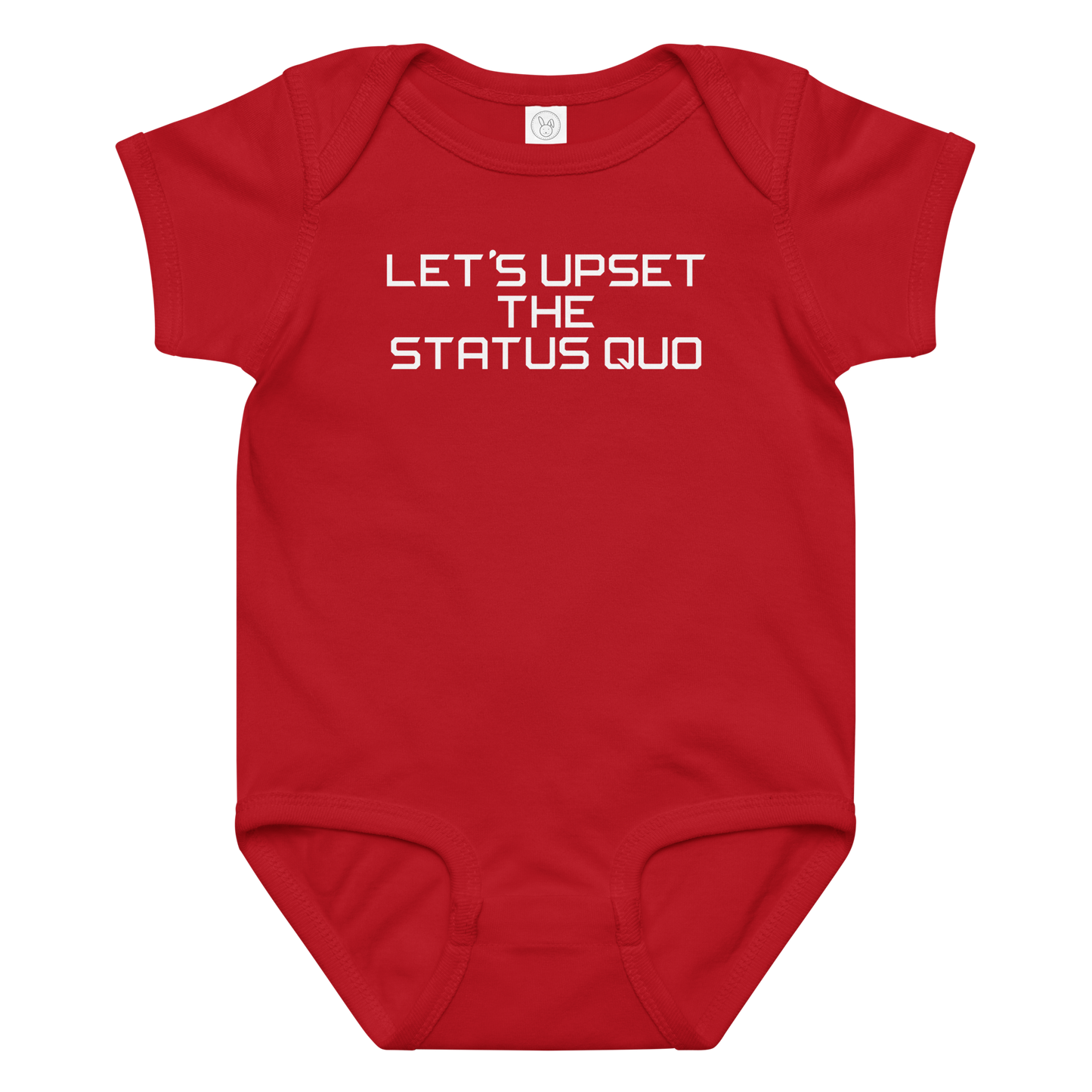 "Let's upset the status quo!" printed on a red baby jersey bodysuit laying on a flat surface amongst other clothes