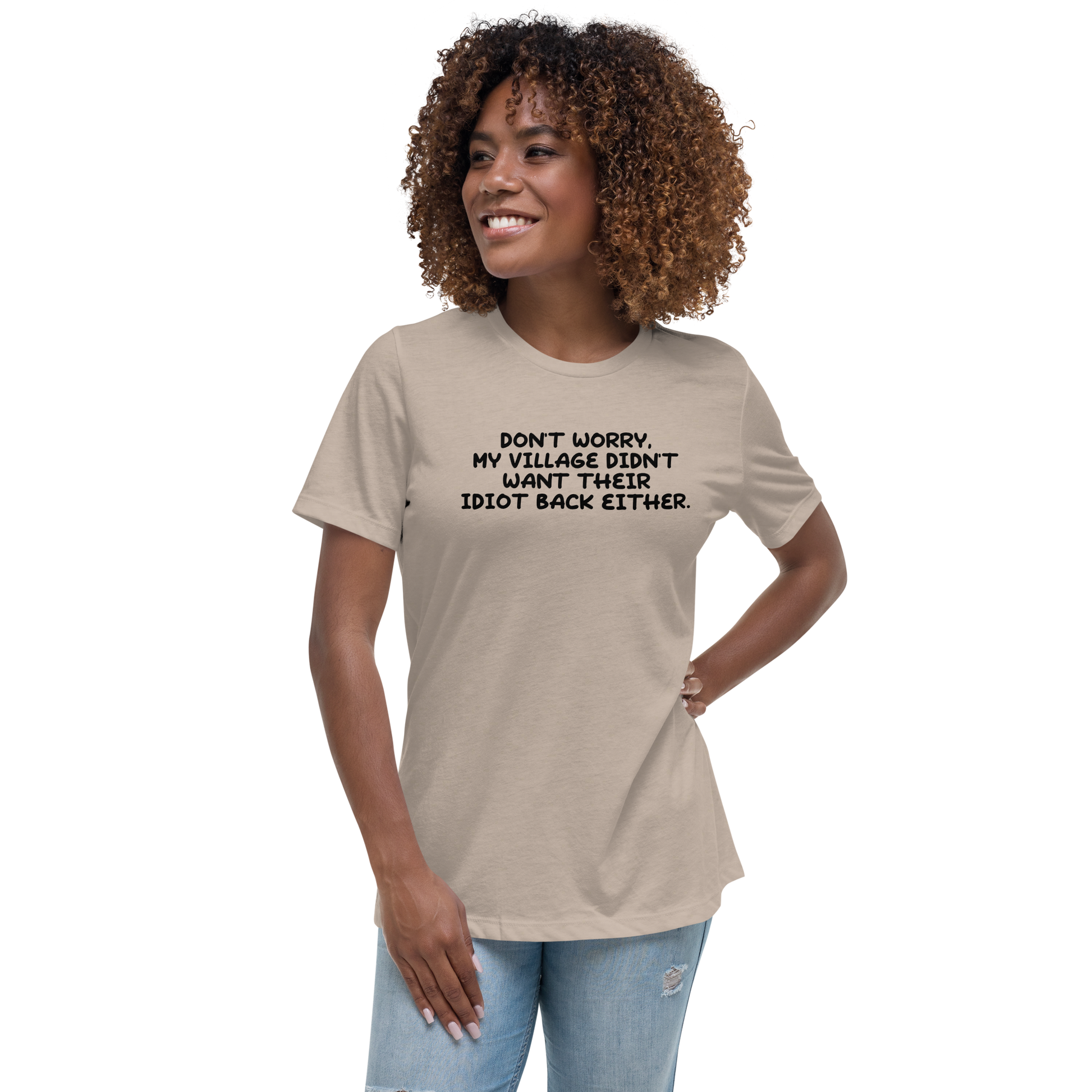 "Don't worry, my village didn’t want their idiot back either." printed on a heather stone women's relaxed t-shirt worn by a female