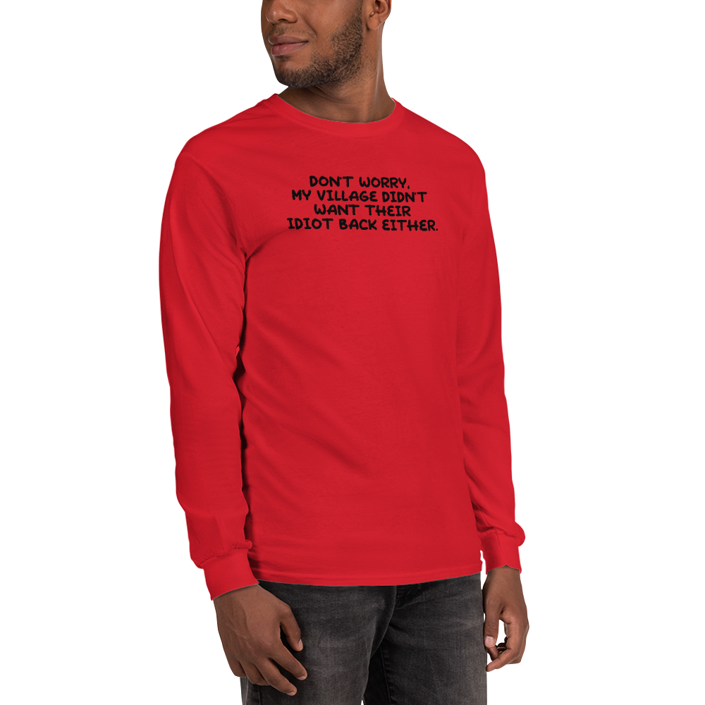 "Don't worry, my village didn’t want their idiot back either." printed on a red men's long sleeve shirt worn by a male
