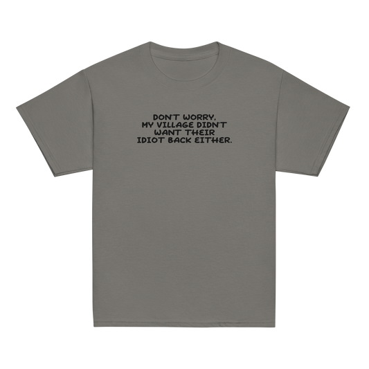 "Don't worry, my village didn’t want their idiot back either." printed on a charcoal youth classic tee laying on a flat surface