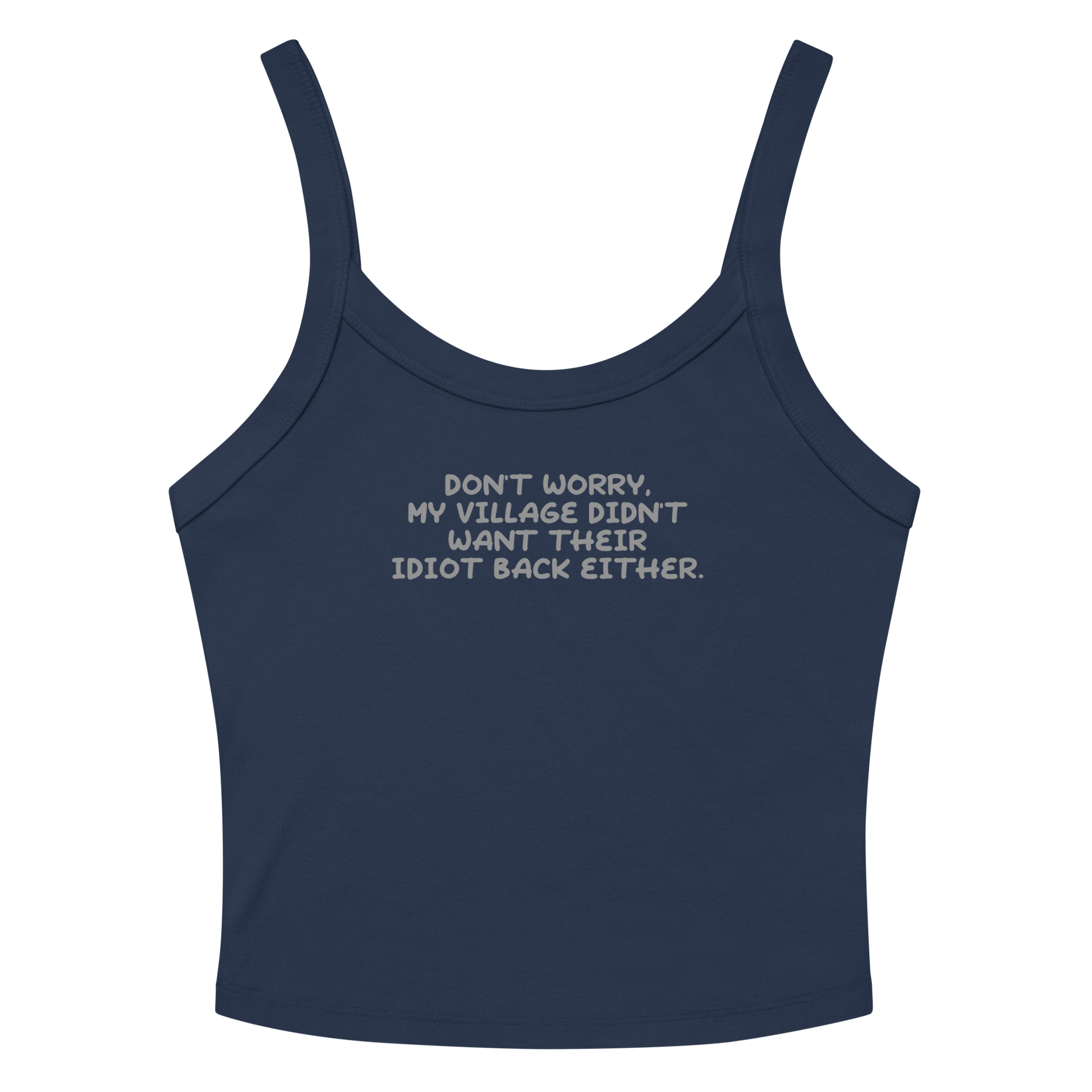 "Don't worry, my village didn’t want their idiot back either." printed on a solid navy blend women's micro-rib tanktop laying on a flat surface amongst sunglasses and shorts