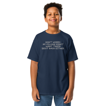 "Don't worry, my village didn’t want their idiot back either." printed on a navy youth classic tee worn by a male