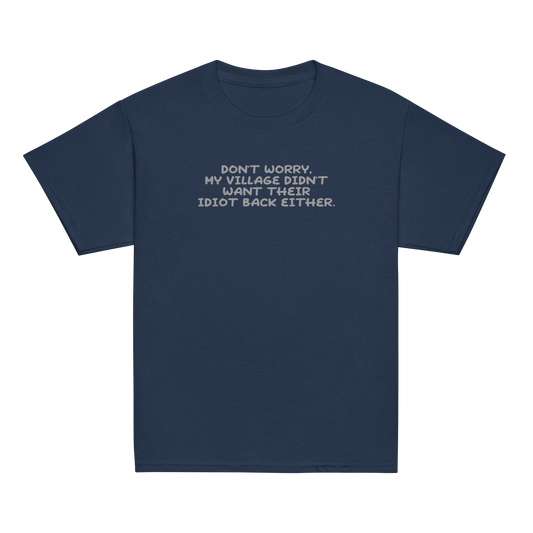 "Don't worry, my village didn’t want their idiot back either." printed on a navy youth classic tee laying on a flat surface