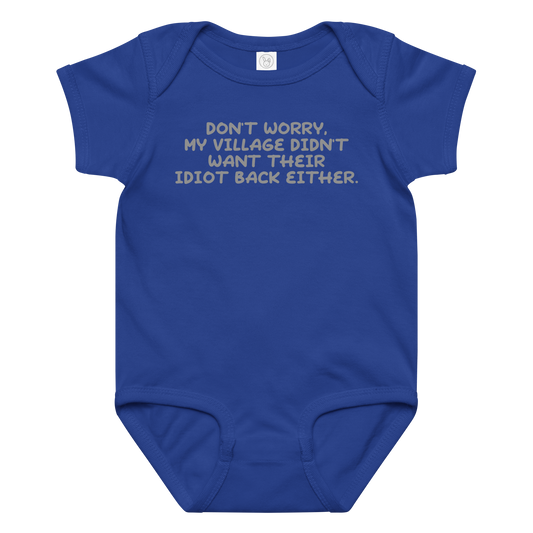 "Don't worry, my village didn’t want their idiot back either." printed on a royal baby jersey bodysuit laying on a flat surface amongst other clothes