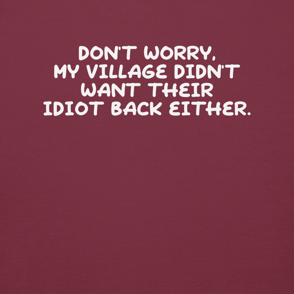 "Don't worry, my village didn’t want their idiot back either." printed on a maroon background