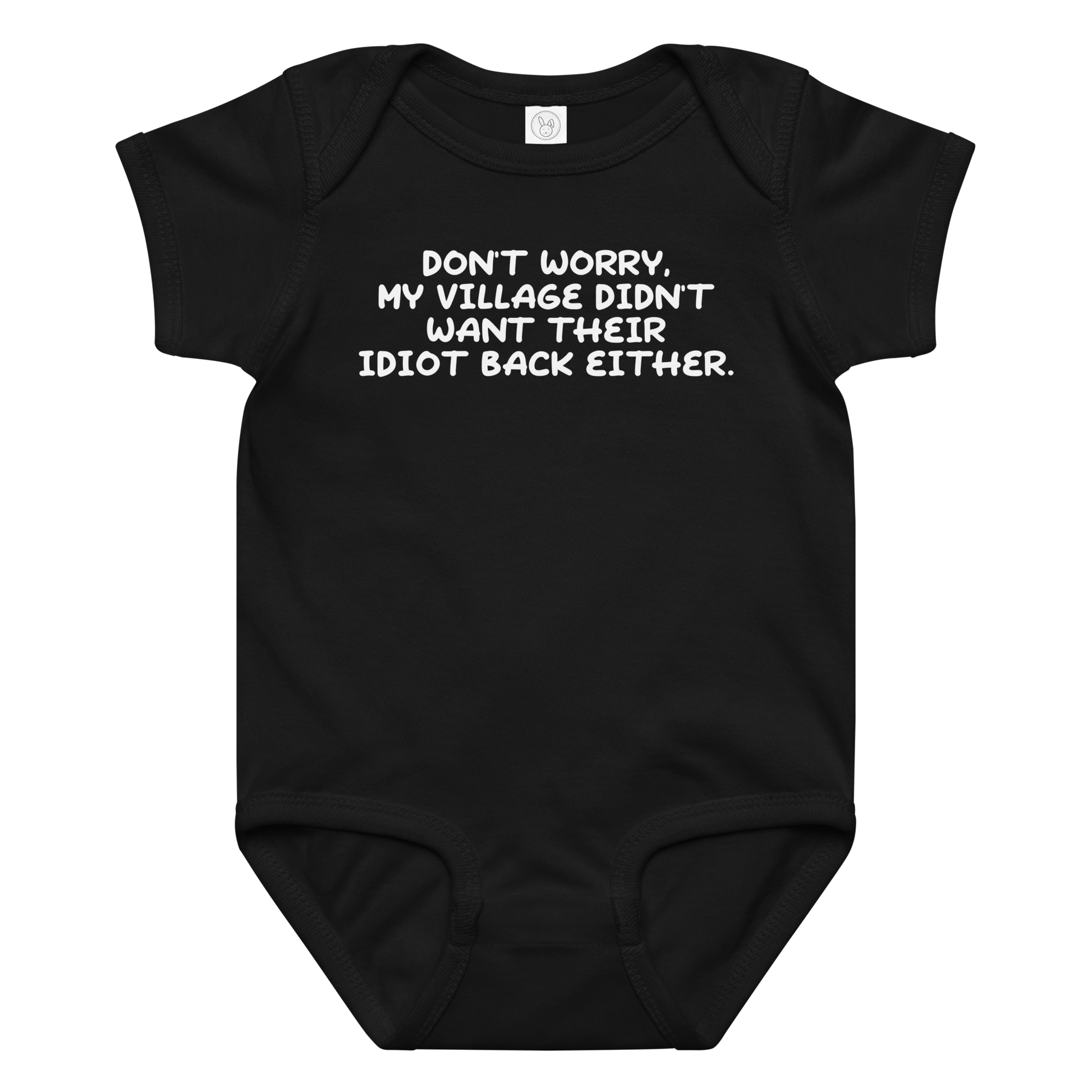 "Don't worry, my village didn’t want their idiot back either." printed on a black baby jersey bodysuit laying on a flat surface amongst other clothes