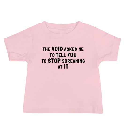 "The Void asked me to tell you to stop screaming at it" printed on a pink baby jersey short sleeve tee laying on a flat surface