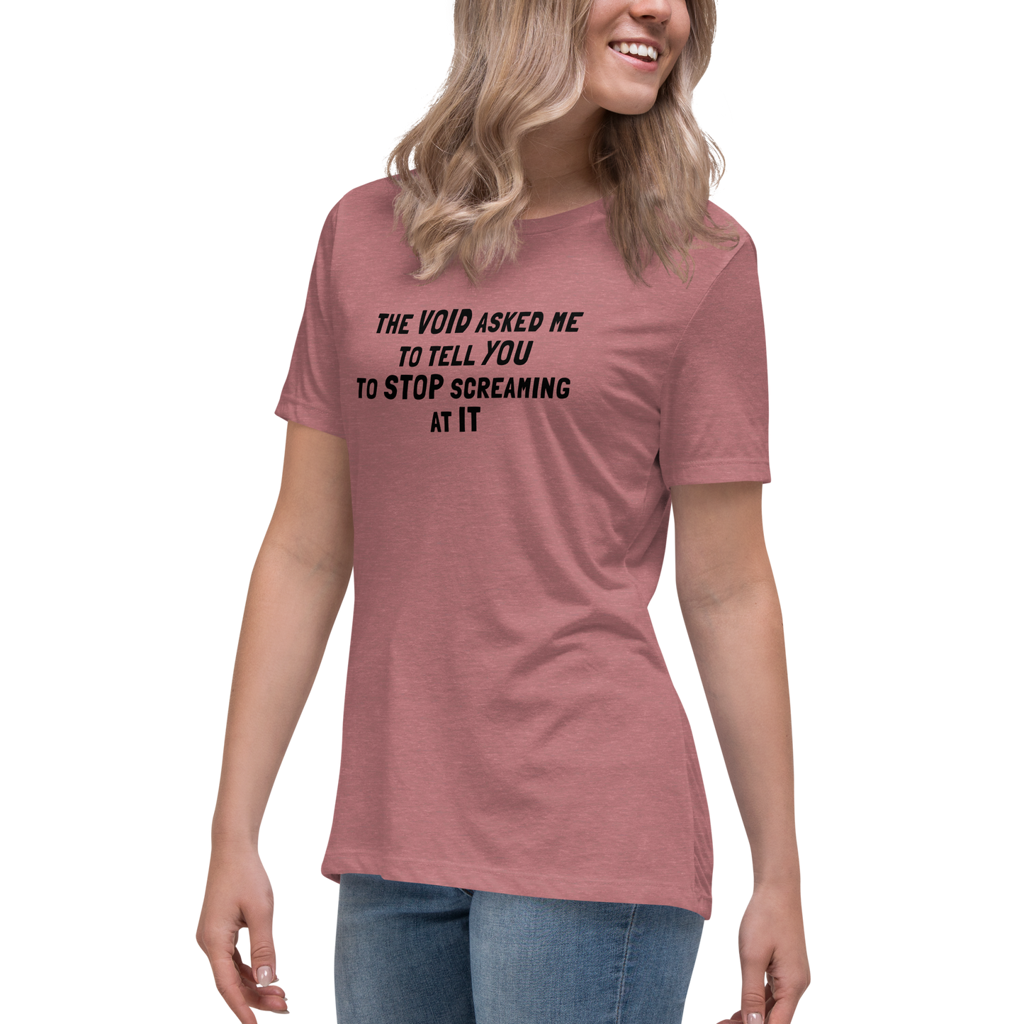 "The Void asked me to tell you to stop screaming at it" printed on a heather mauve women's relaxed t-shirt worn by a female