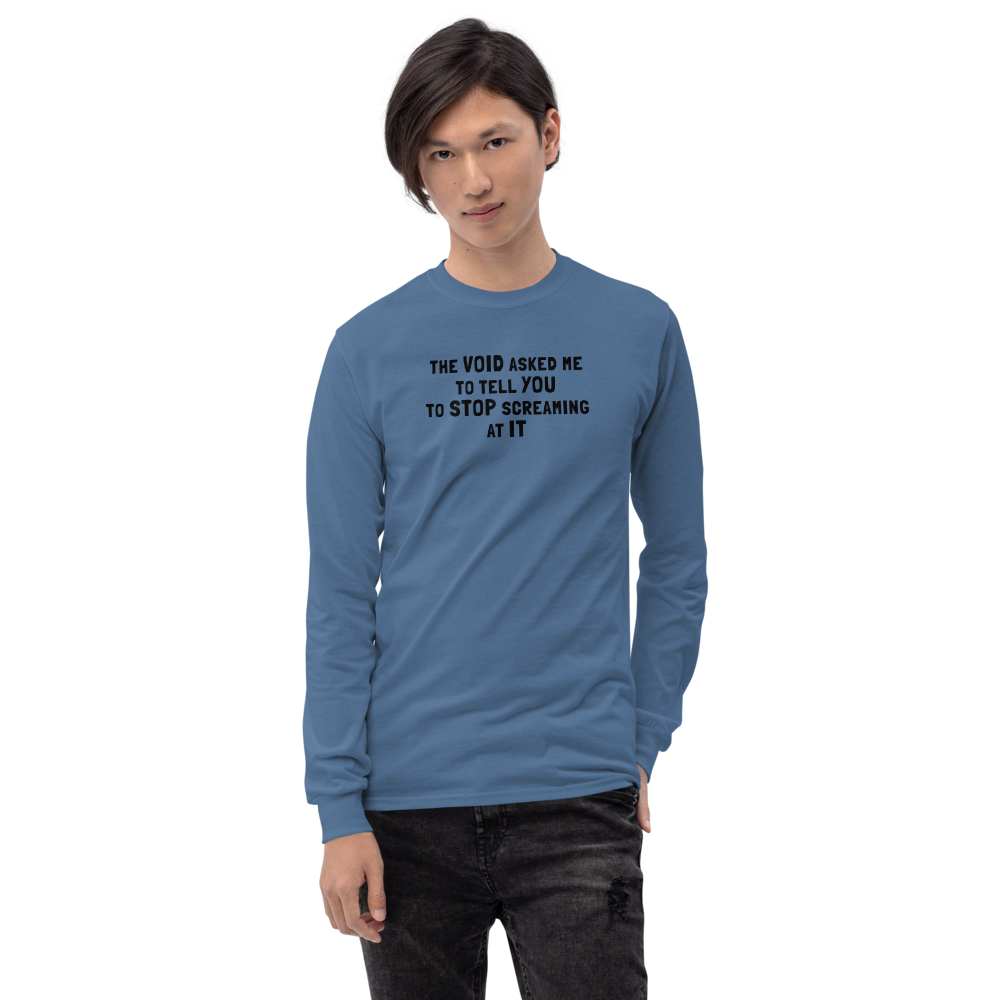 "The Void asked me to tell you to stop screaming at it" printed on a indigo blue men's long sleeve shirt worn by a male