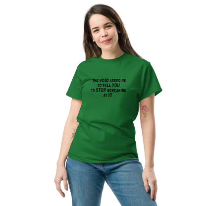 "The Void asked me to tell you to stop screaming at it" printed on a turf green unisex classic tee worn by a female