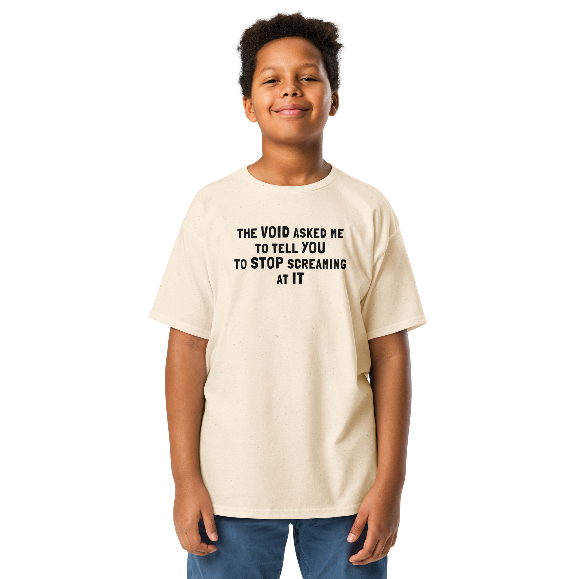 "The Void asked me to tell you to stop screaming at it" printed on a natural youth classic tee worn by a male