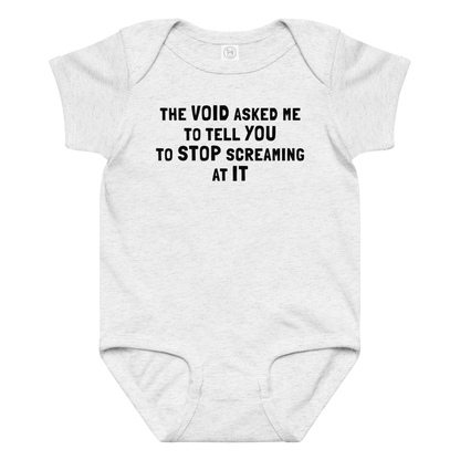"The Void asked me to tell you to stop screaming at it" printed on a ash baby jersey bodysuit laying on a flat surface amongst other clothes