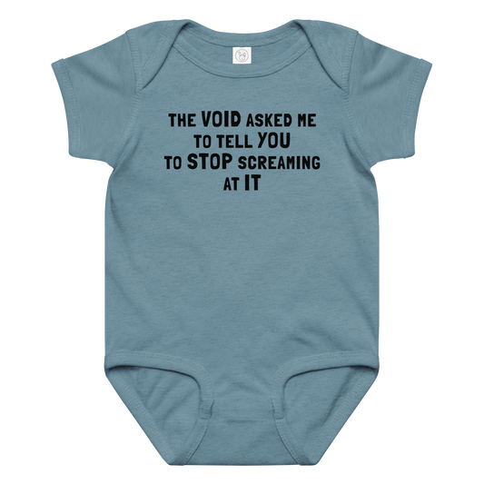 "The Void asked me to tell you to stop screaming at it" printed on a vintage indigo baby jersey bodysuit laying on a flat surface amongst other clothes