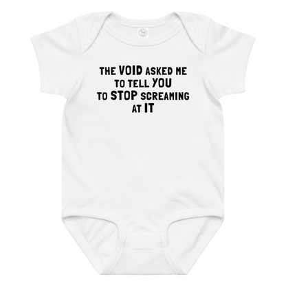 "The Void asked me to tell you to stop screaming at it" printed on a white baby jersey bodysuit laying on a flat surface amongst other clothes