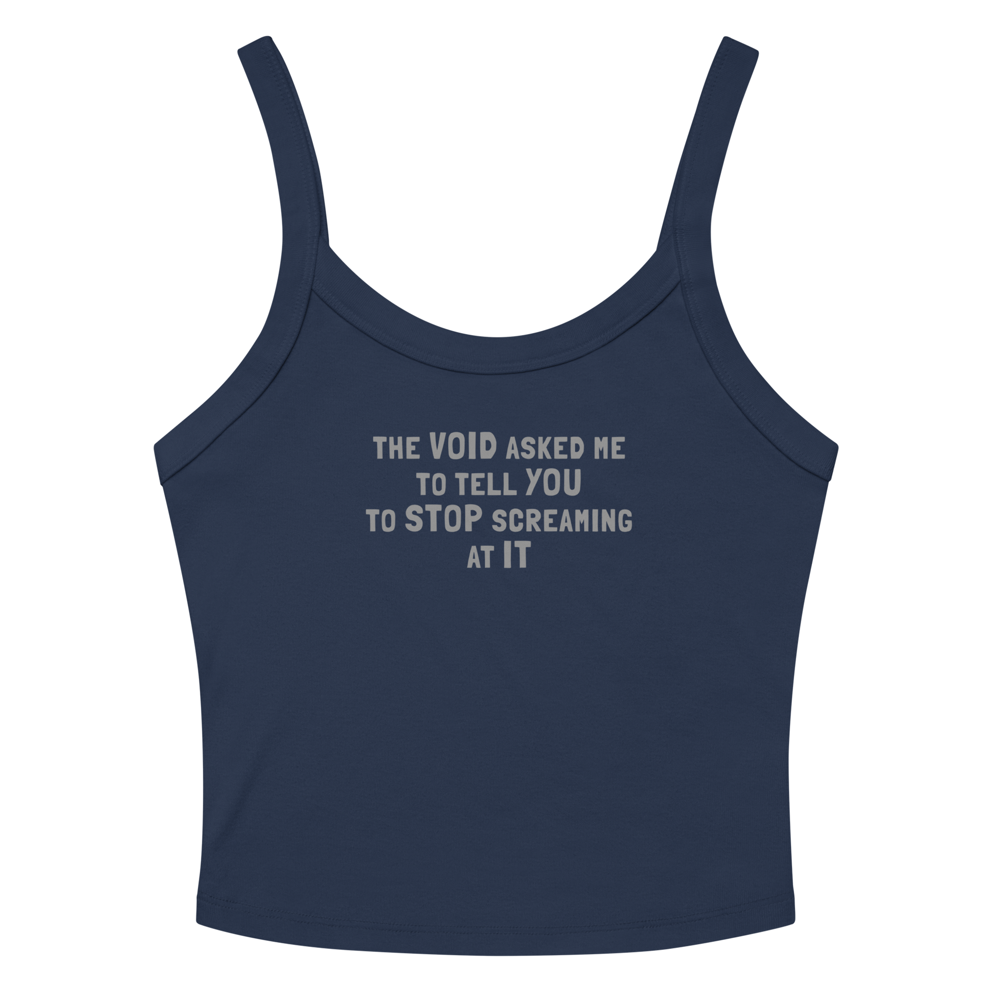 "The Void asked me to tell you to stop screaming at it" printed on a solid navy blend women's micro-rib tanktop laying on a flat surface amongst sunglasses and shorts