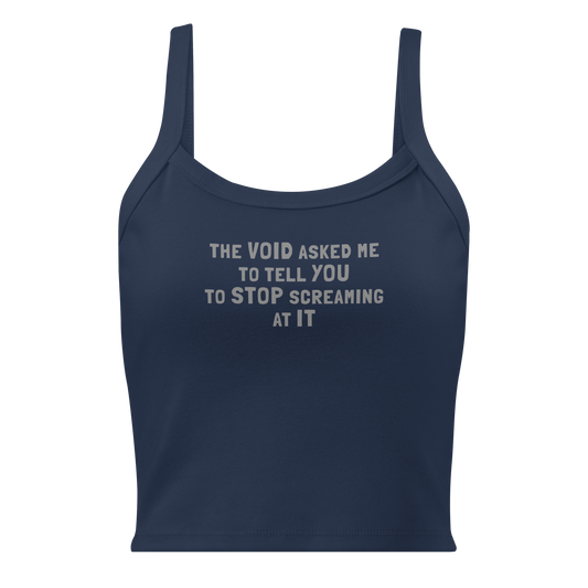 "The Void asked me to tell you to stop screaming at it" printed on a solid navy blend women's micro-rib tanktop laying on a flat surface
