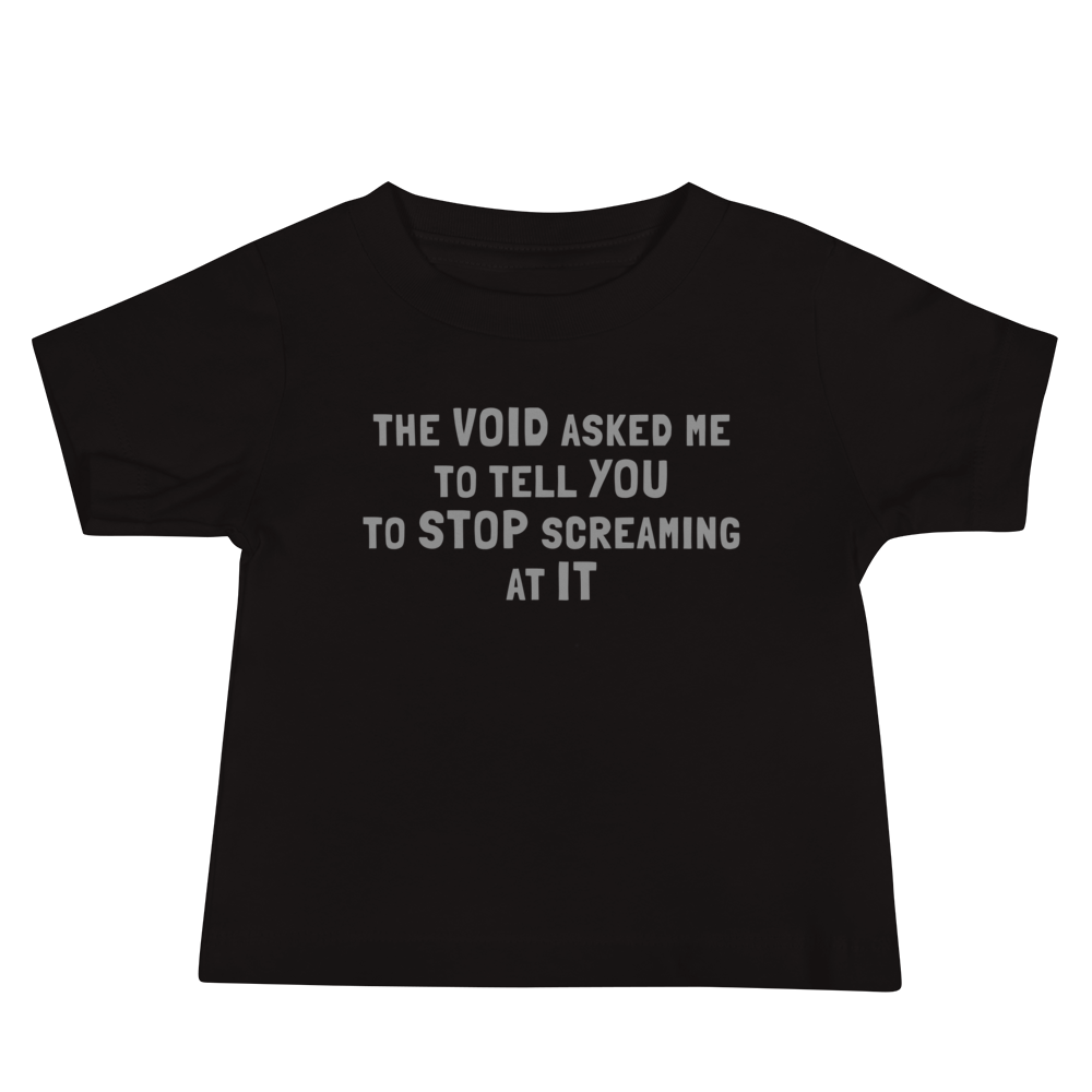 "The Void asked me to tell you to stop screaming at it" printed on a black baby jersey short sleeve tee laying on a flat surface