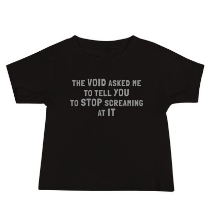 "The Void asked me to tell you to stop screaming at it" printed on a black baby jersey short sleeve tee laying on a flat surface