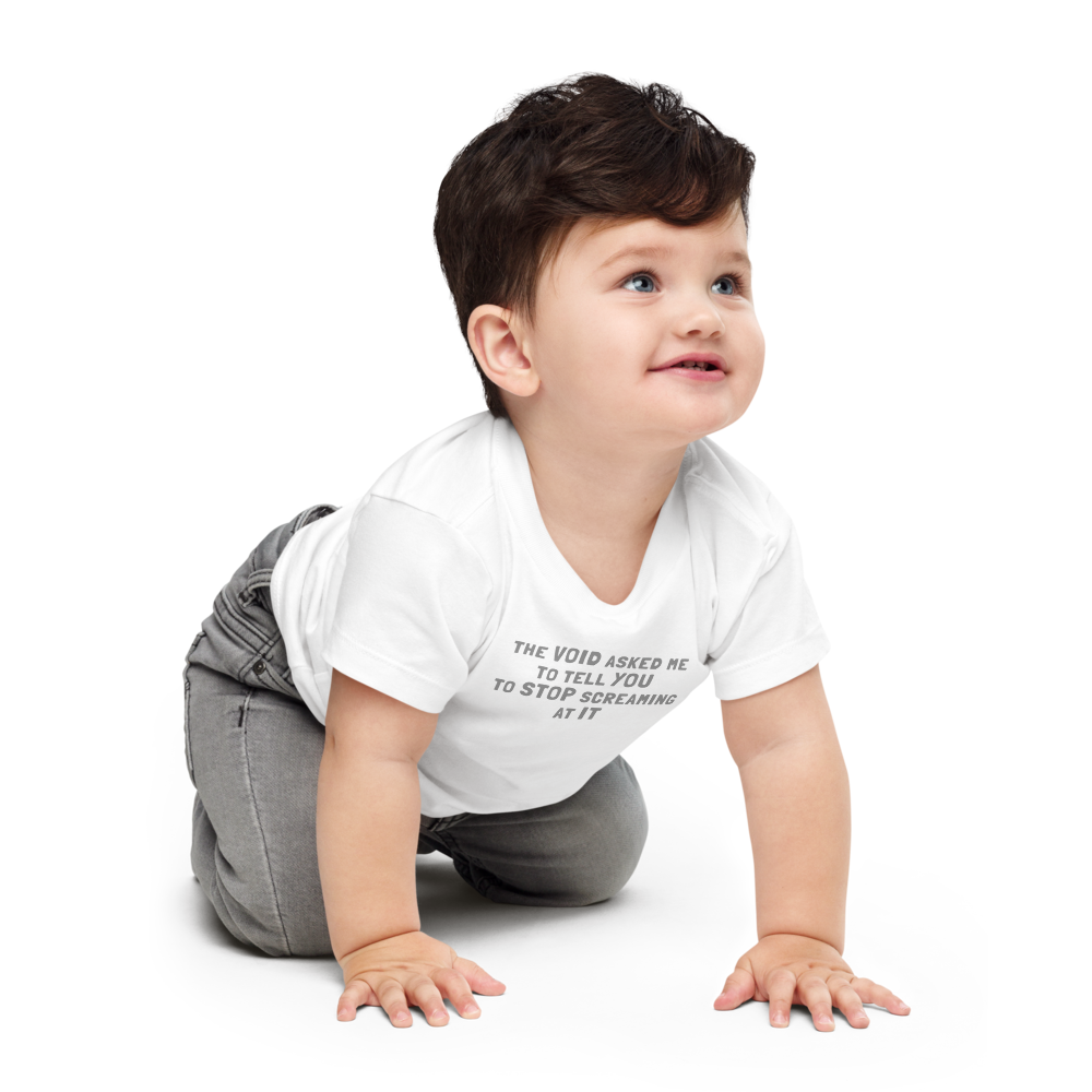 "The Void asked me to tell you to stop screaming at it" printed on a white baby jersey short sleeve tee worn by a male who is crawling