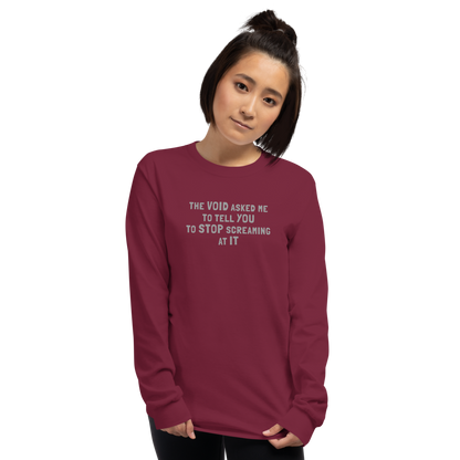 "The Void asked me to tell you to stop screaming at it" printed on a maroon men's long sleeve shirt worn by a female