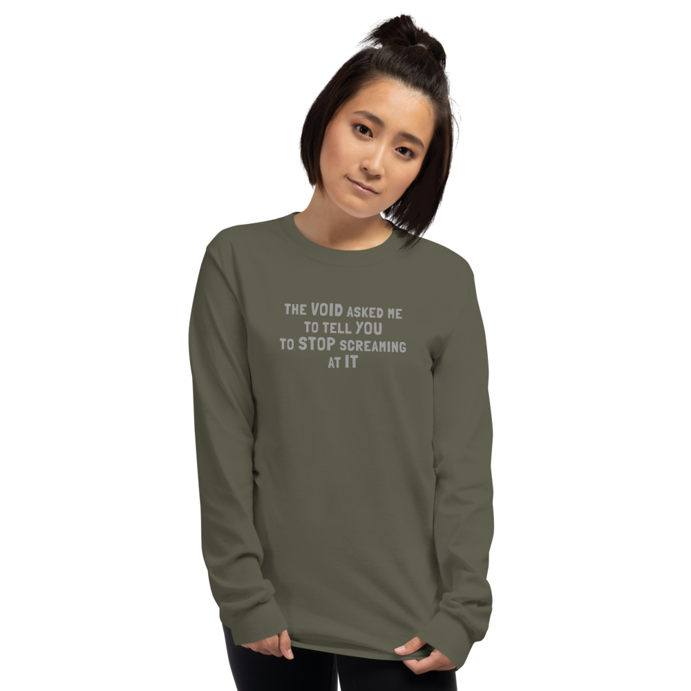 "The Void asked me to tell you to stop screaming at it" printed on a military green men's long sleeve shirt worn by a female