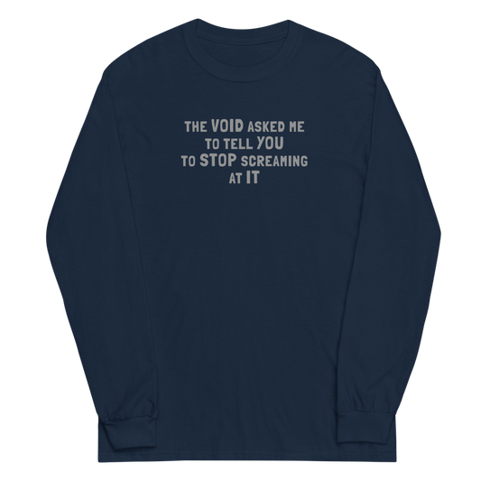 "The Void asked me to tell you to stop screaming at it" printed on a navy men's long sleeve shirt laying on a flat surface