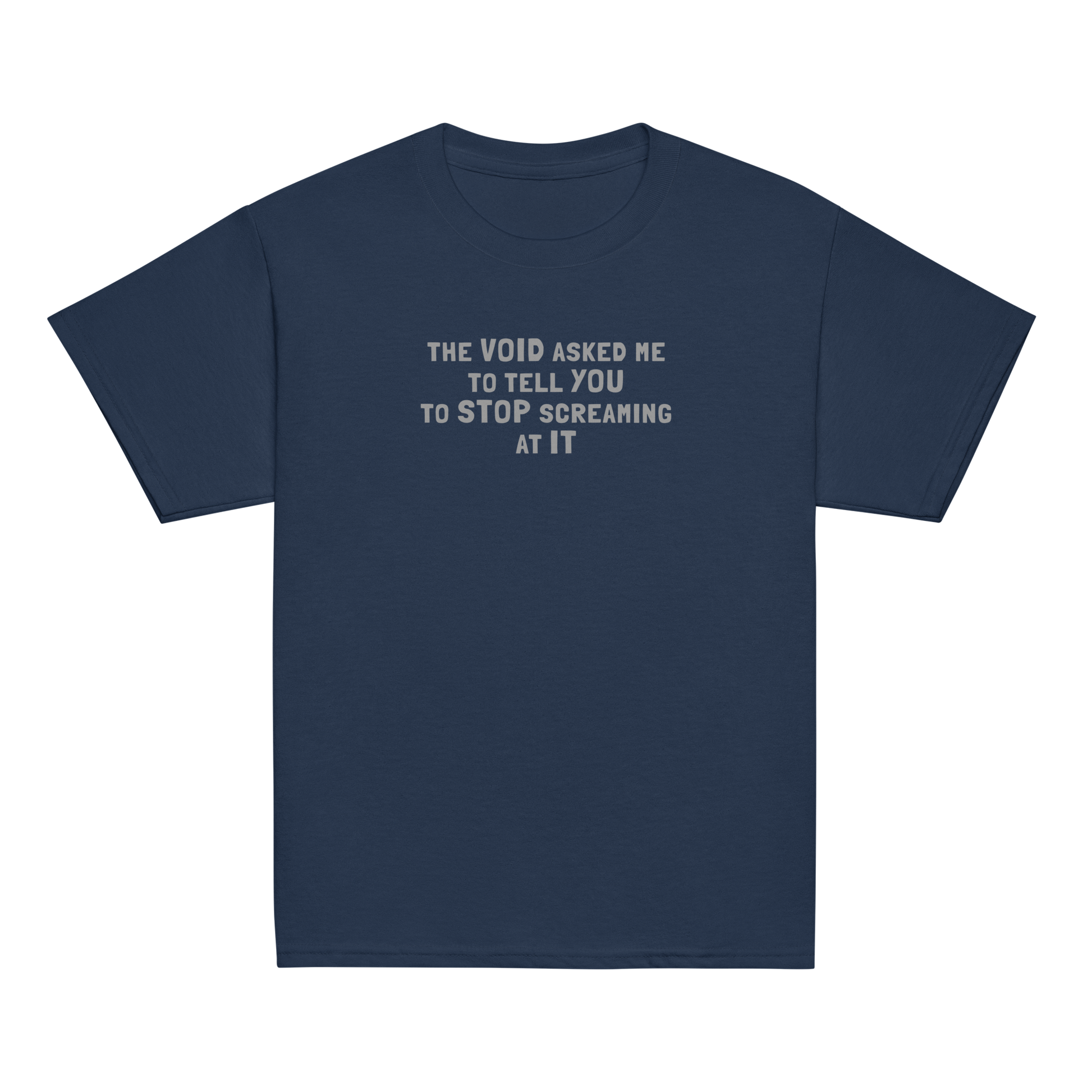 "The Void asked me to tell you to stop screaming at it" printed on a navy youth classic tee laying on a flat surface